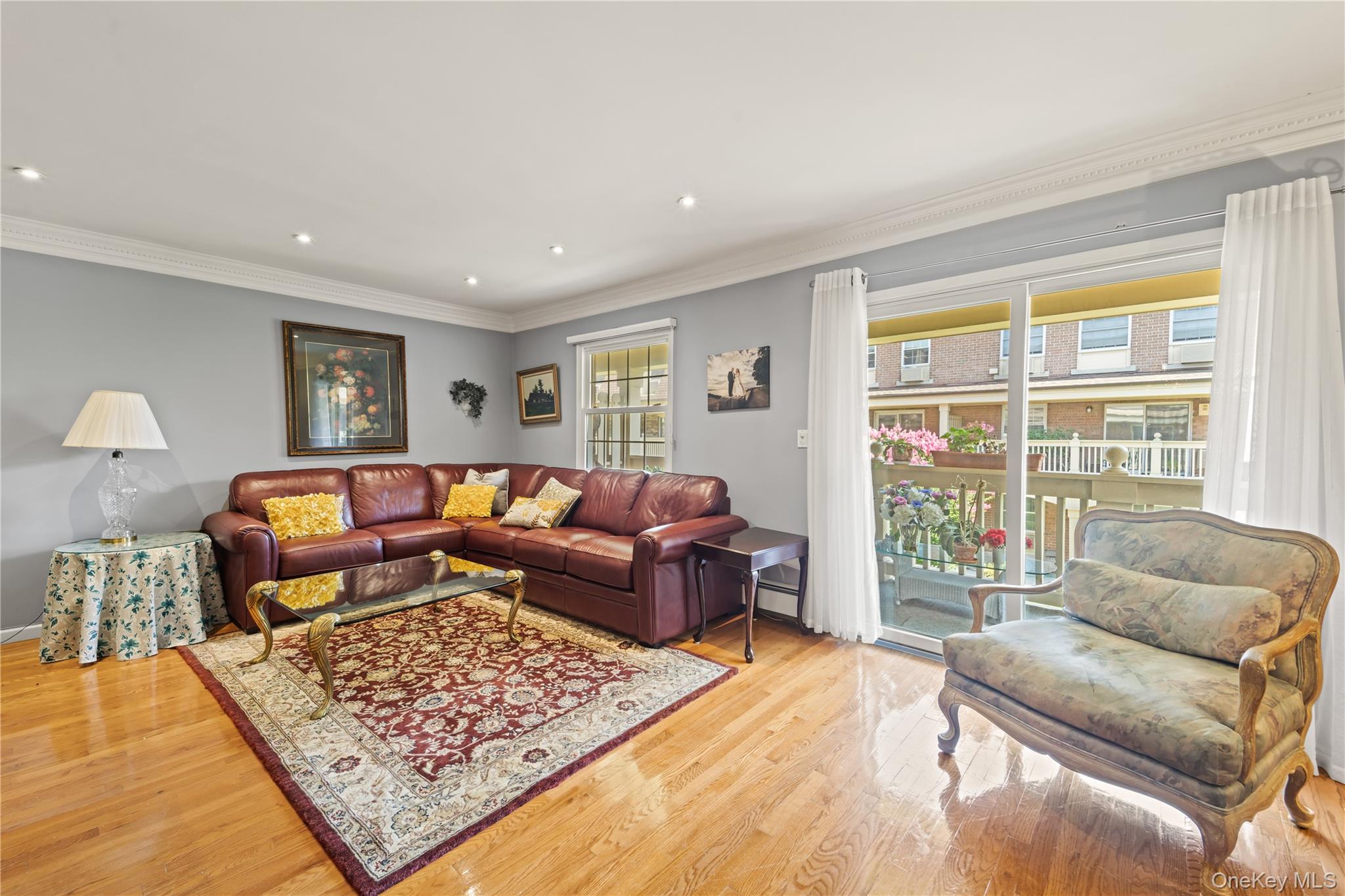 12-35 Robin Lane, Unit UPPR Queens, NY 11360 - Photo 2 of 23 Living area with ornamental molding, light wood-style flooring, and recessed lighting