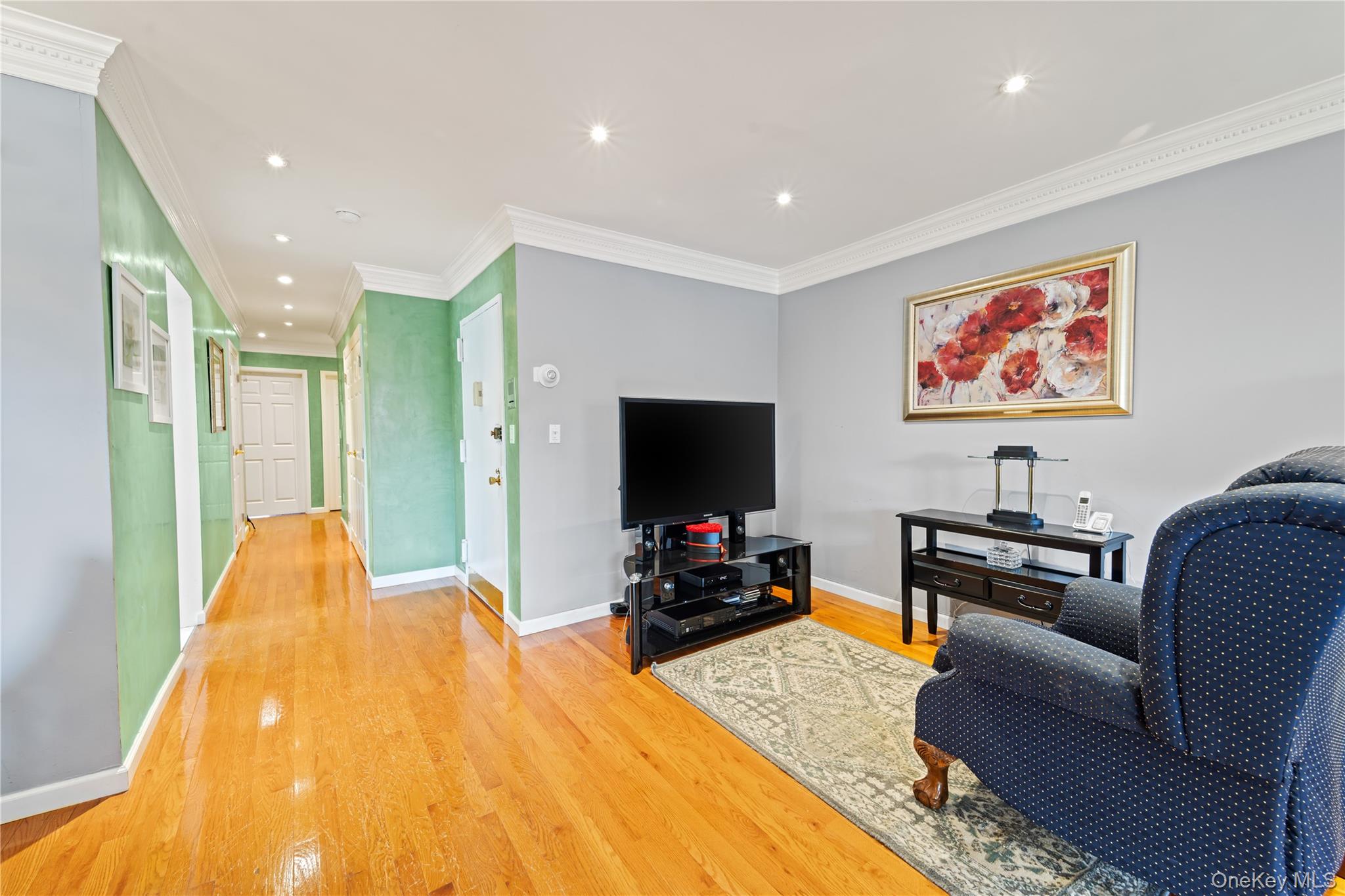 12-35 Robin Lane, Unit UPPR Queens, NY 11360 - Photo 7 of 23 Living area featuring crown molding, recessed lighting, and light wood-style floors