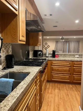 a stove top oven sitting inside of a kitchen