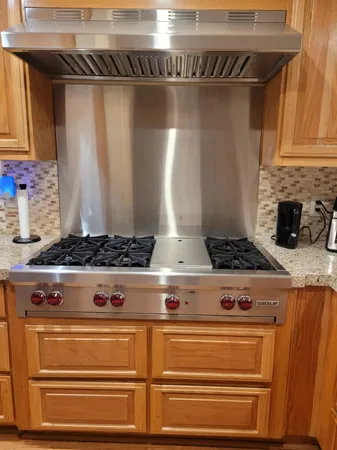 a kitchen with stainless steel appliances granite countertop a stove and a refrigerator