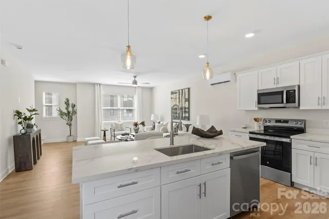 a kitchen with sink stove and cabinets