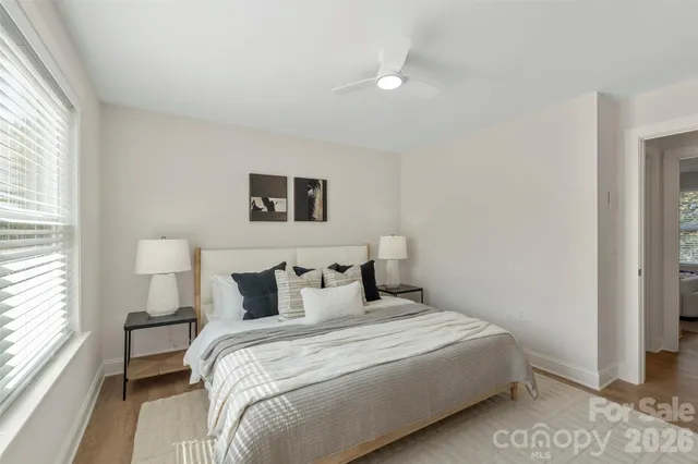 a bedroom with a bed and a large window