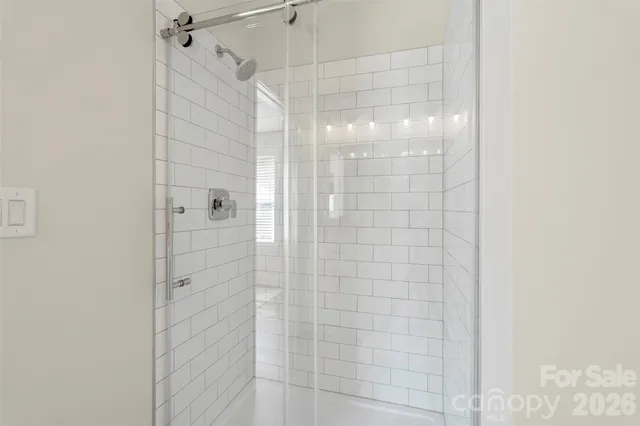 a bathroom with a glass shower door