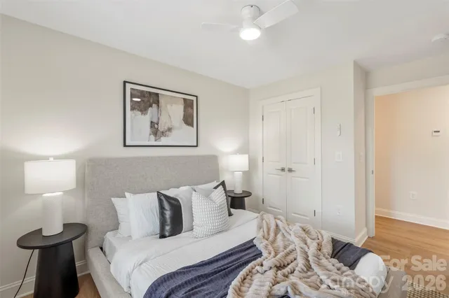 a bedroom with a bed and a lamp