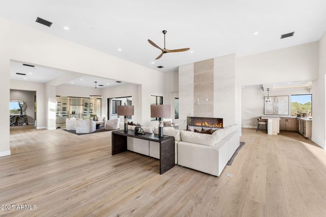 a large kitchen with stainless steel appliances lots of counter space and wooden floor