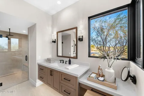a bathroom with a double vanity sink toilet and shower