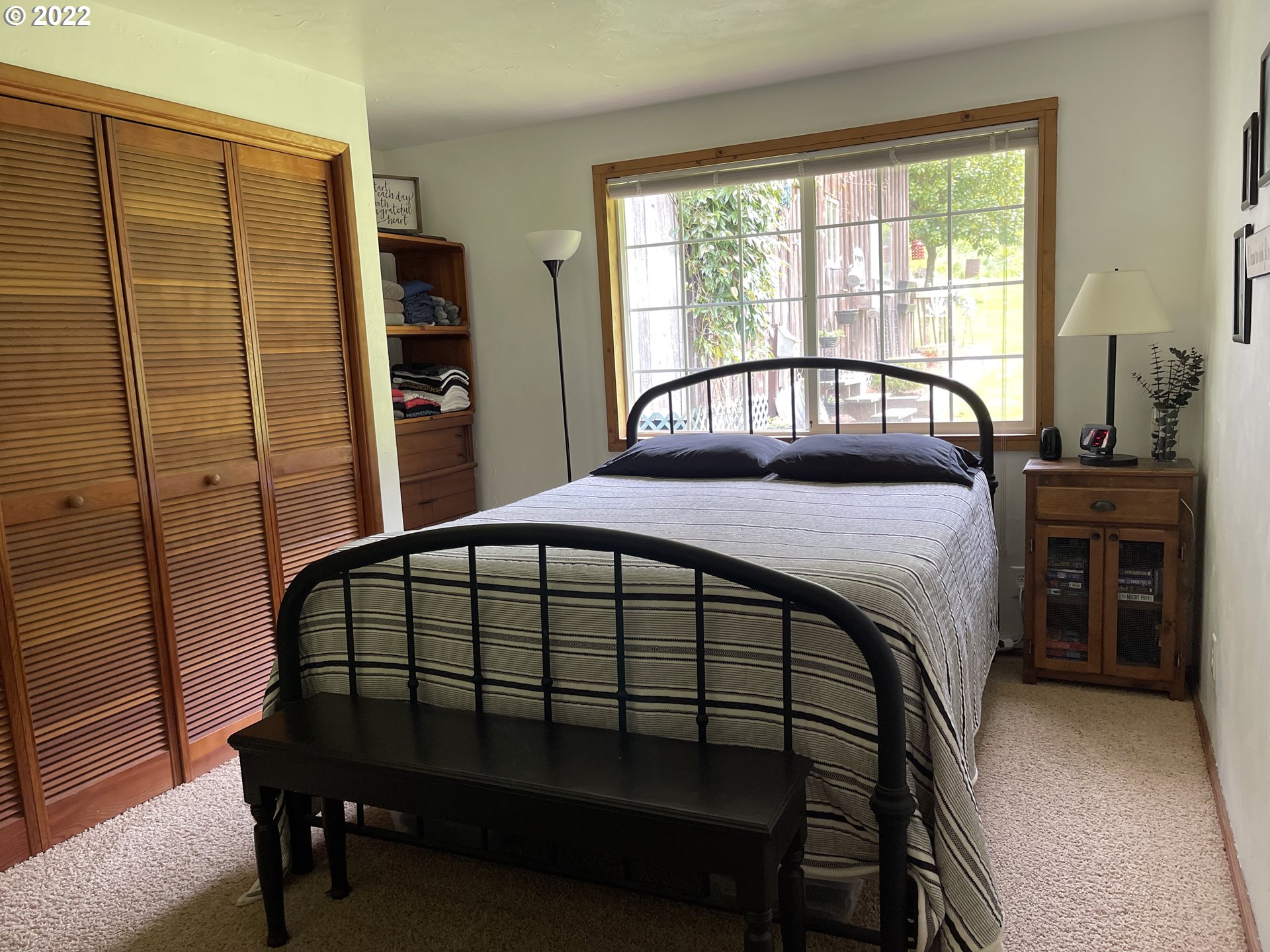 1891 Oar Creek Road Reedsport, OR 97467 - Photo 31 of 31 a bedroom with a bed window and a table in it