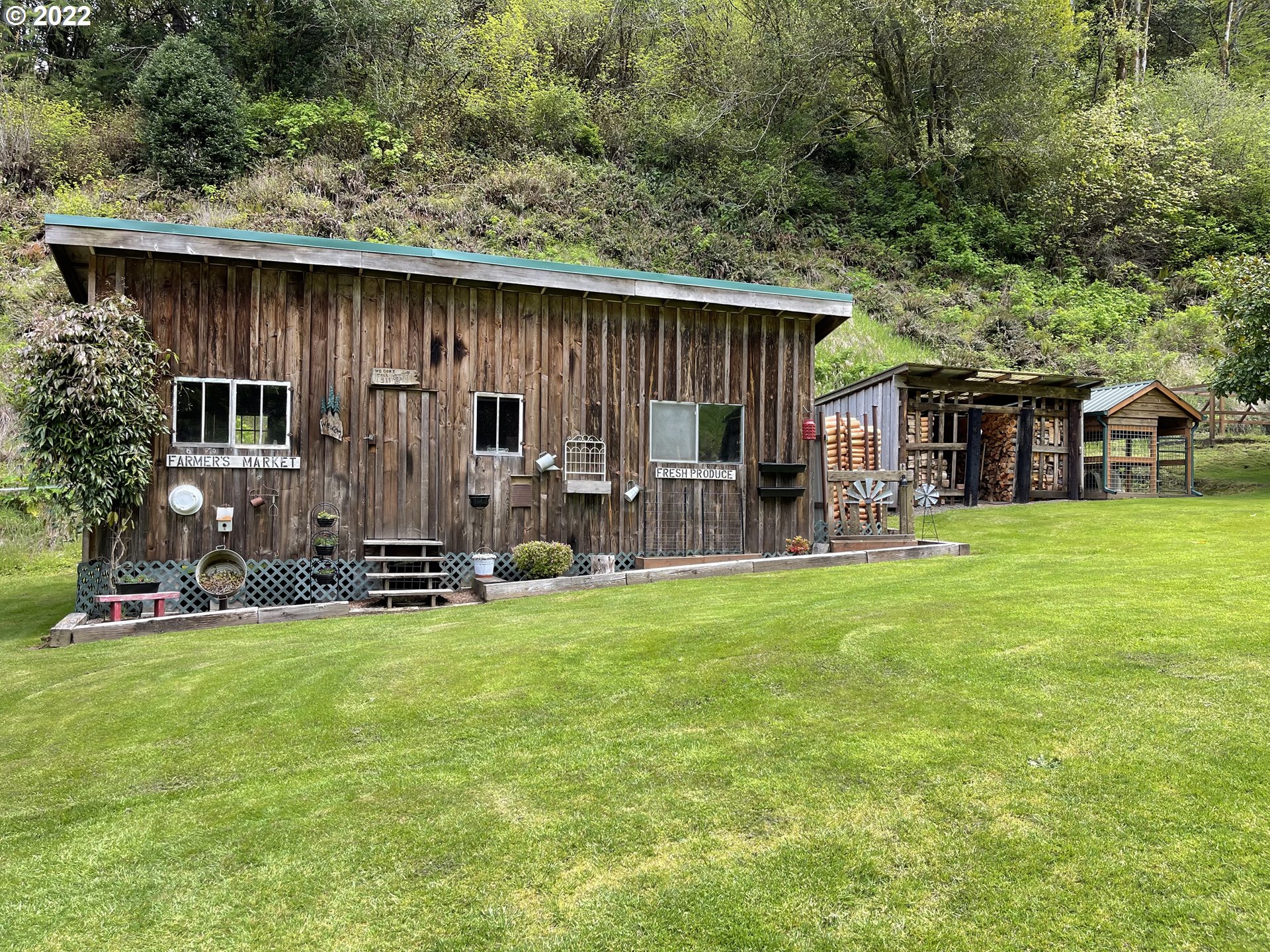 1891 Oar Creek Road Reedsport, OR 97467 - Photo 7 of 31 a backyard of a house with table and chairs