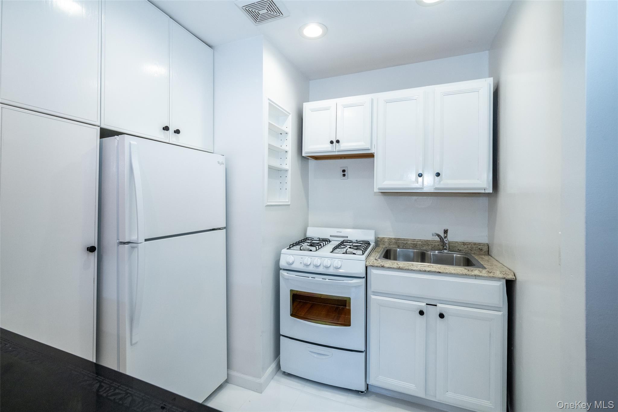 2221 Palmer Avenue, Unit 3D New Rochelle, NY 10801 - Photo 3 of 18 a kitchen with a refrigerator sink stove and cabinets