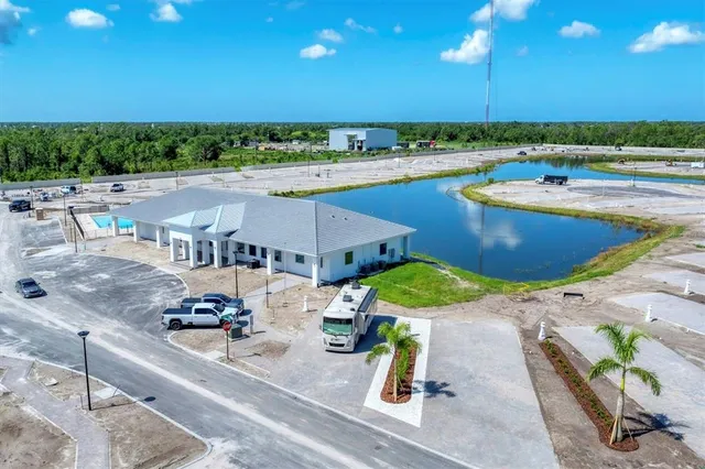 a front view of a house with garden and trees