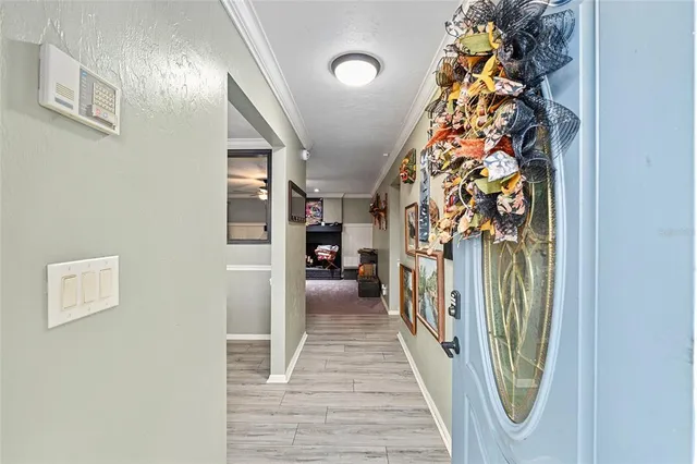 a kitchen with a sink a stove and chairs with wooden floor