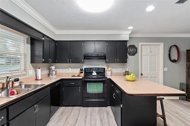 a bathroom with a granite countertop toilet and a sink