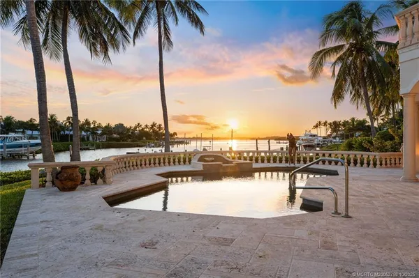 a view of a lake with a table and chairs
