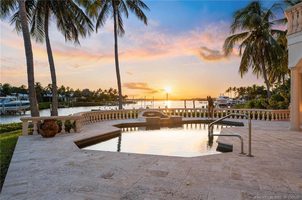 2440 Bahia Way Stuart, FL 34996 - Photo 11 of 67 a view of a lake with a table and chairs