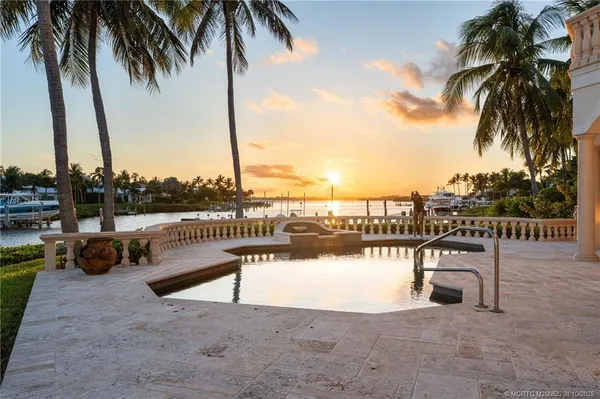 a view of a lake with a table and chairs
