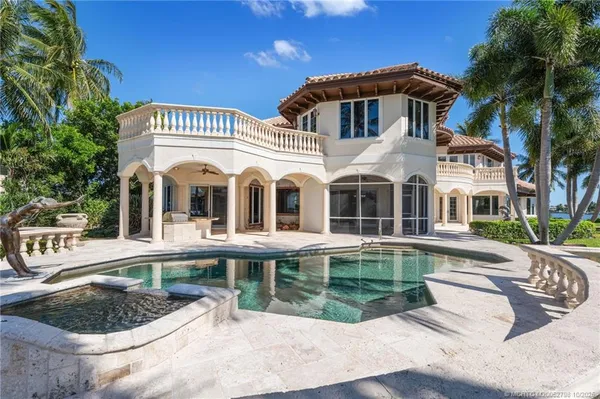 a view of a lake with couches chairs