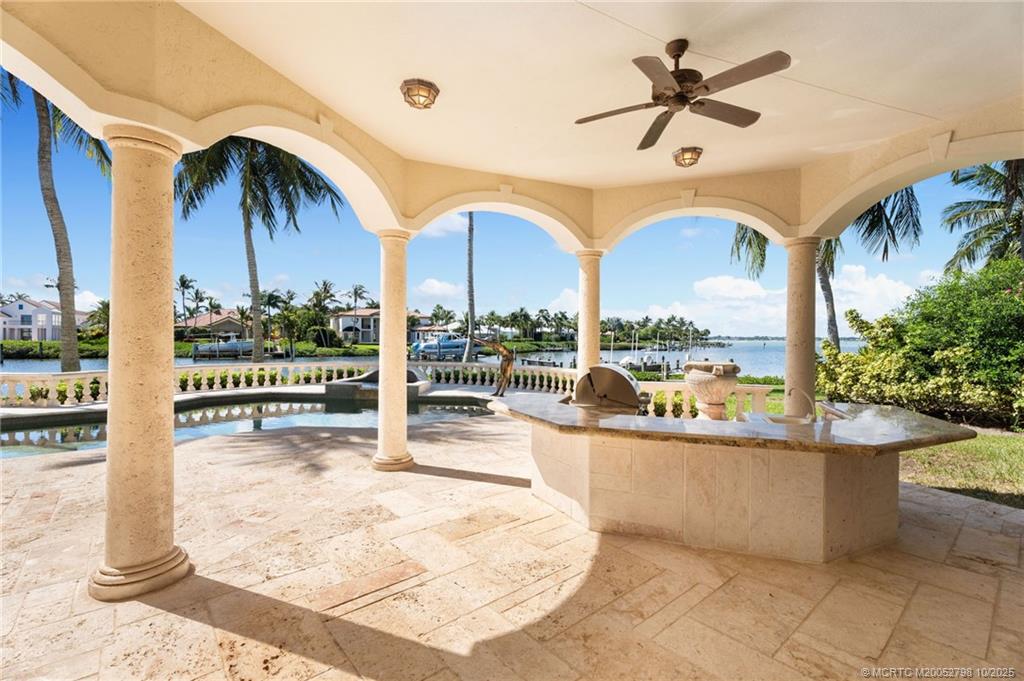 2440 Bahia Way Stuart, FL 34996 - Photo 24 of 67 a view of a swimming pool with a chair and tables