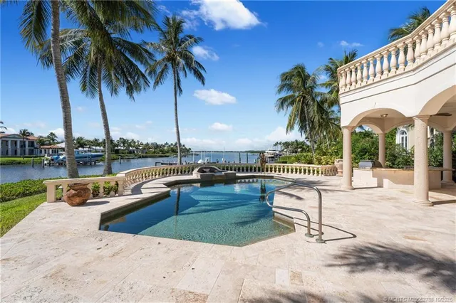 a view of a lake with couches chairs