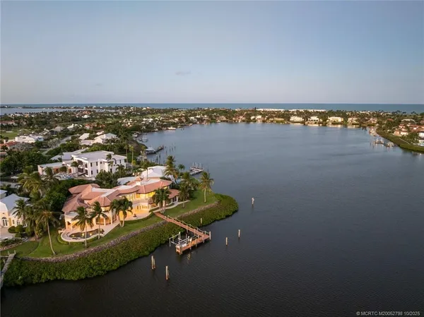 an aerial view of a house with a lake view