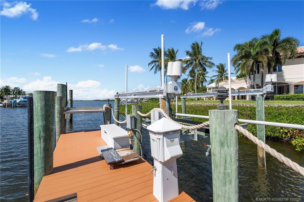 2440 Bahia Way Stuart, FL 34996 - Photo 35 of 67 a view of a swimming pool with outdoor seating and plants