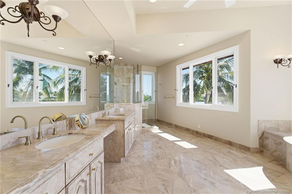 2440 Bahia Way Stuart, FL 34996 - Photo 45 of 67 a bathroom with a granite countertop sink a large mirror and a window
