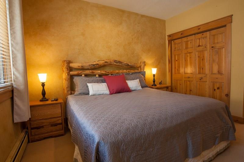 188 Tip Top Trail, Unit 6559 Keystone, CO 80435 - Photo 13 of 24 a bedroom with a bed and wooden floor