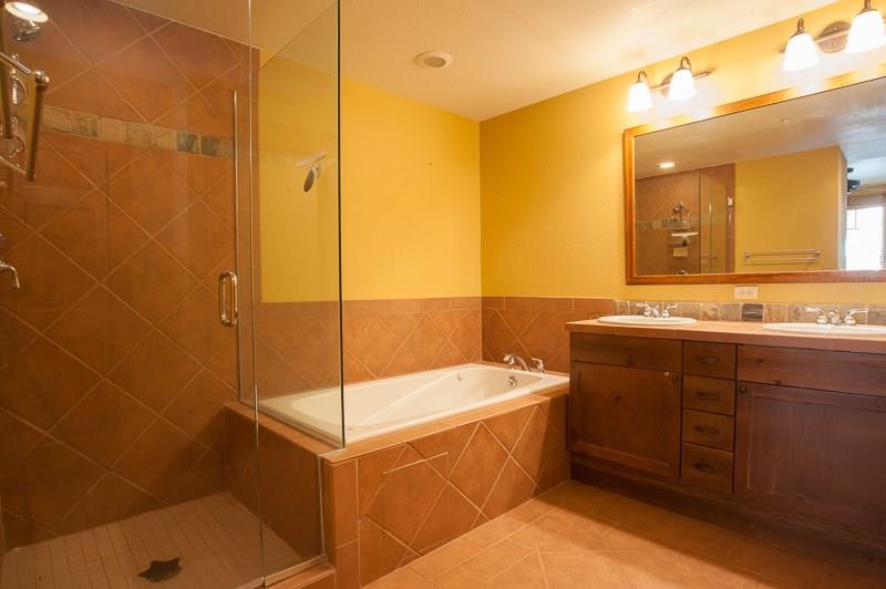 188 Tip Top Trail, Unit 6559 Keystone, CO 80435 - Photo 14 of 24 a bathroom with a tub sink and mirror