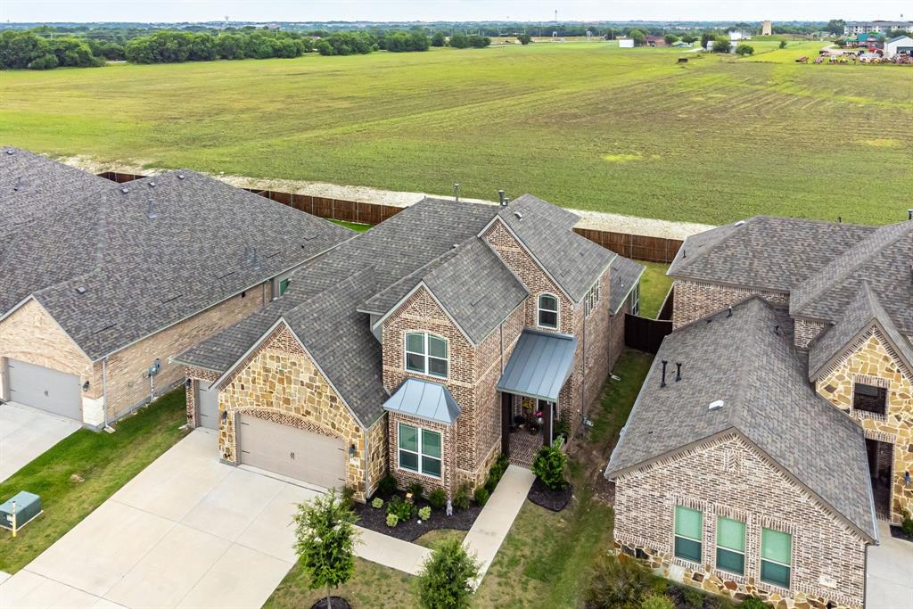 313 Tate Lane Anna, TX 75409 - Photo 2 of 30 Contemporary two-story residence featuring a combination of brick and stone masonry