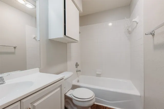 a bathroom with a sink a toilet and a bathtub