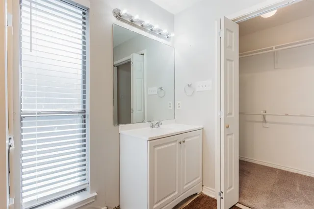 a view of a bathroom with a sink and mirror