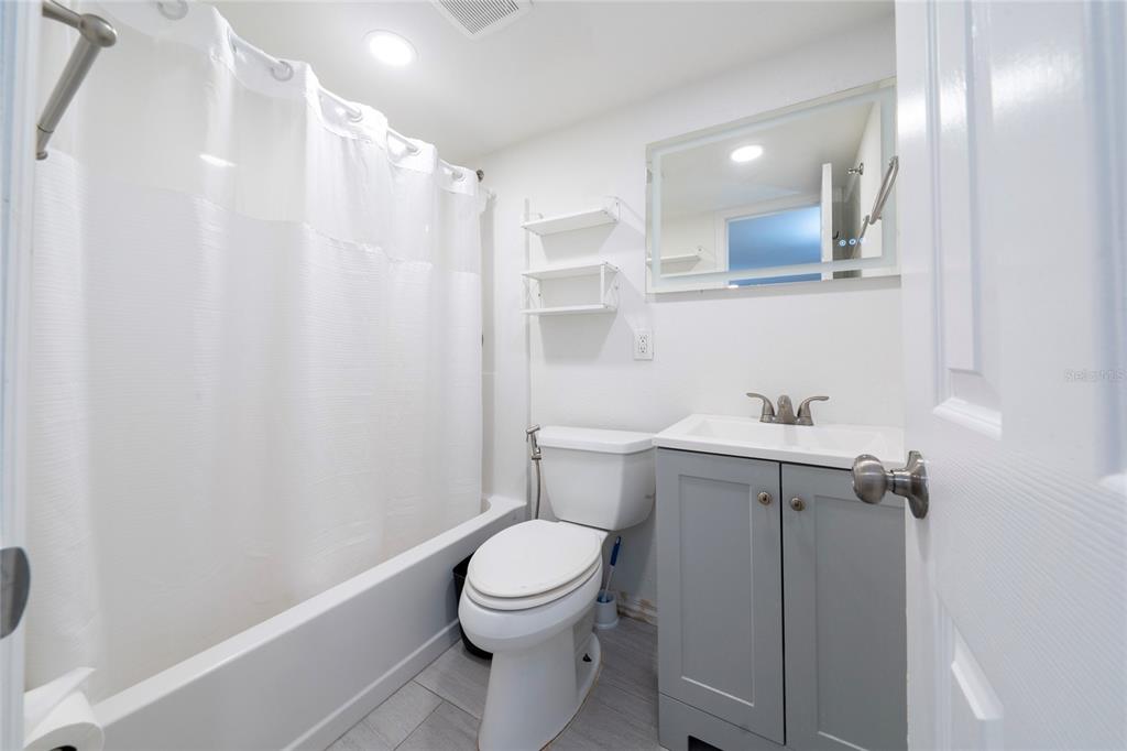 357 Ridgewood Street Altamonte Springs, FL 32701 - Photo 33 of 36 a white toilet sitting next to a bathroom sink