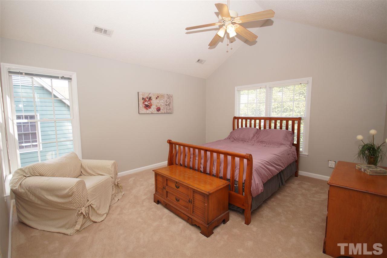 12317 Hartwick Court Raleigh, NC 27613 - Photo 12 of 24 a spacious bedroom with a bed and window