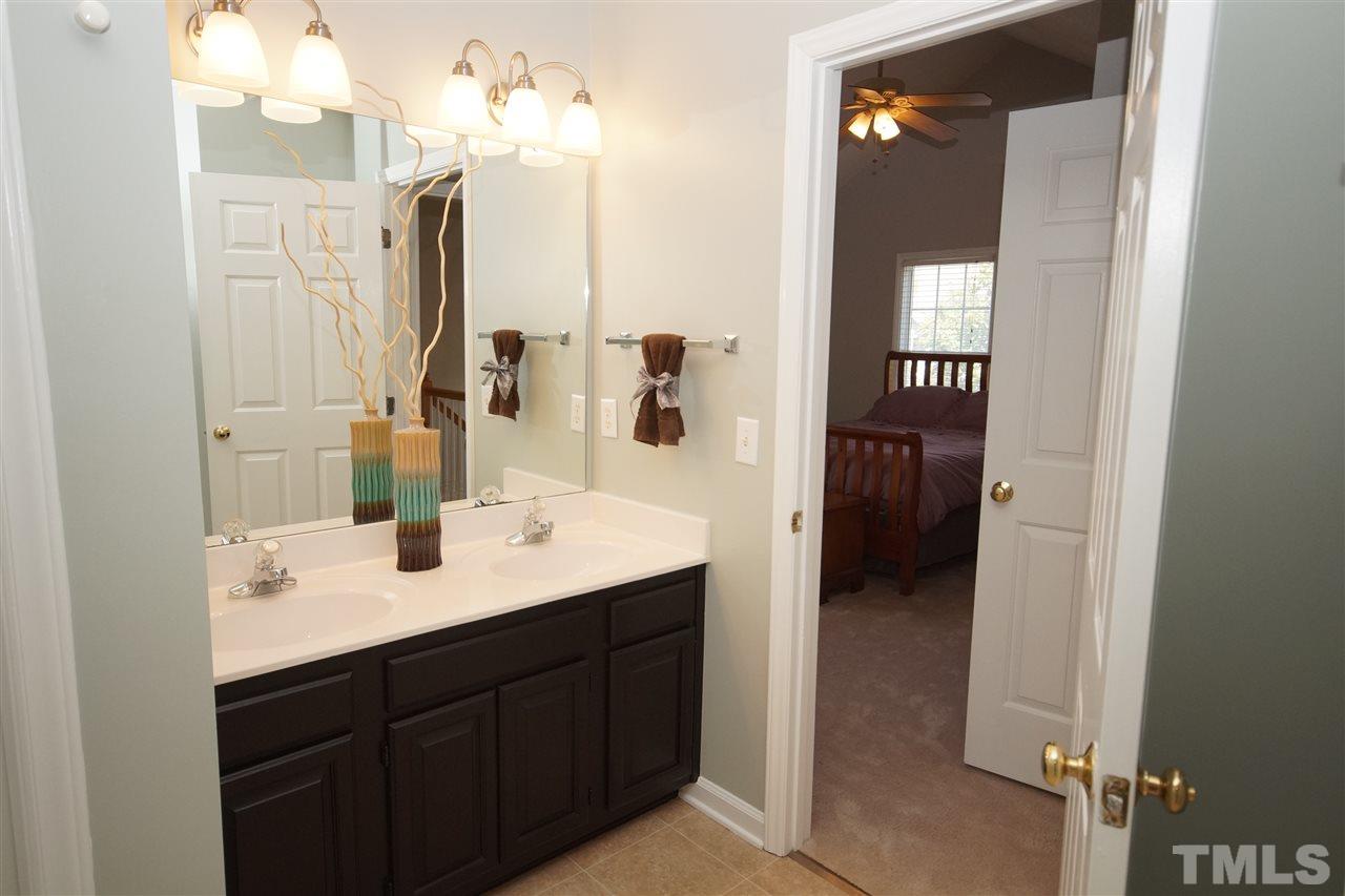 12317 Hartwick Court Raleigh, NC 27613 - Photo 14 of 24 a en suite bathroom with a double vanity sink and mirror