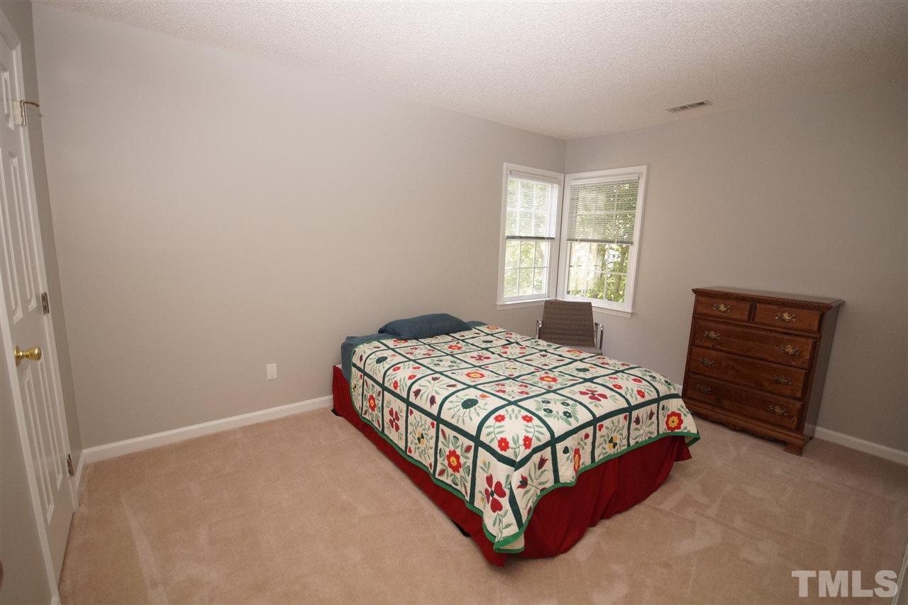 12317 Hartwick Court Raleigh, NC 27613 - Photo 18 of 24 a bedroom with a bed and a window