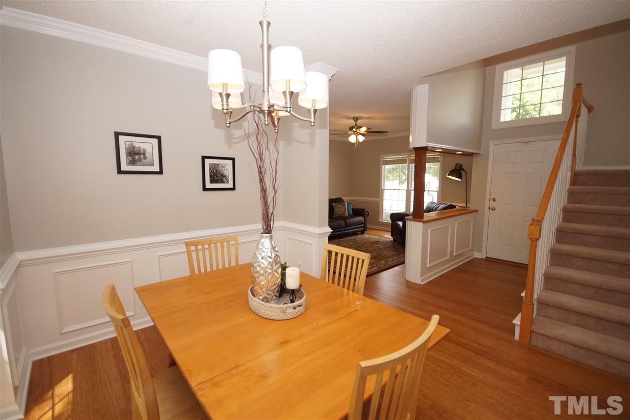 12317 Hartwick Court Raleigh, NC 27613 - Photo 3 of 24 a view of a dining room with furniture and a chandelier