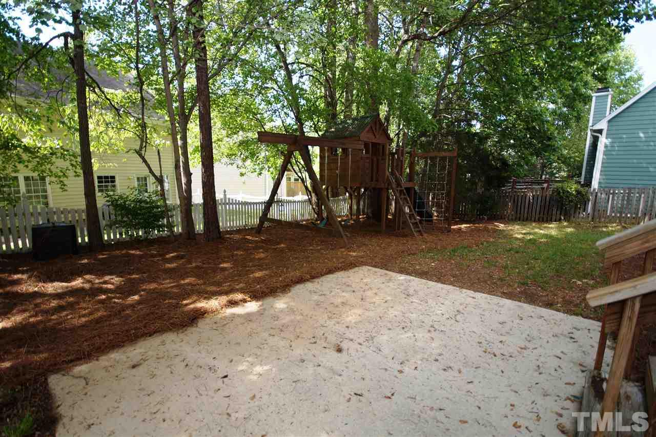 12317 Hartwick Court Raleigh, NC 27613 - Photo 23 of 24 a backyard of a house with lots of green space