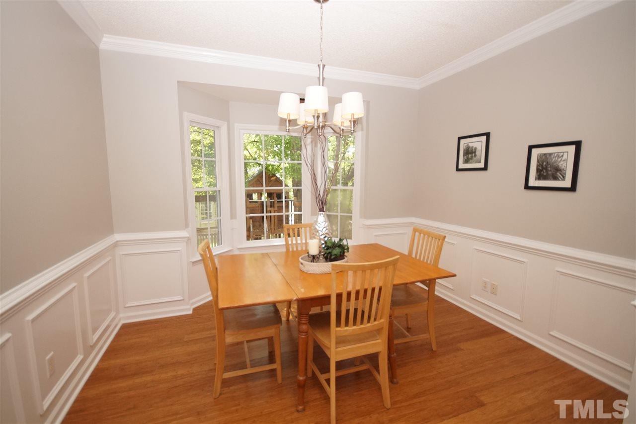 12317 Hartwick Court Raleigh, NC 27613 - Photo 4 of 24 a view of a dining room with furniture window and wooden floor