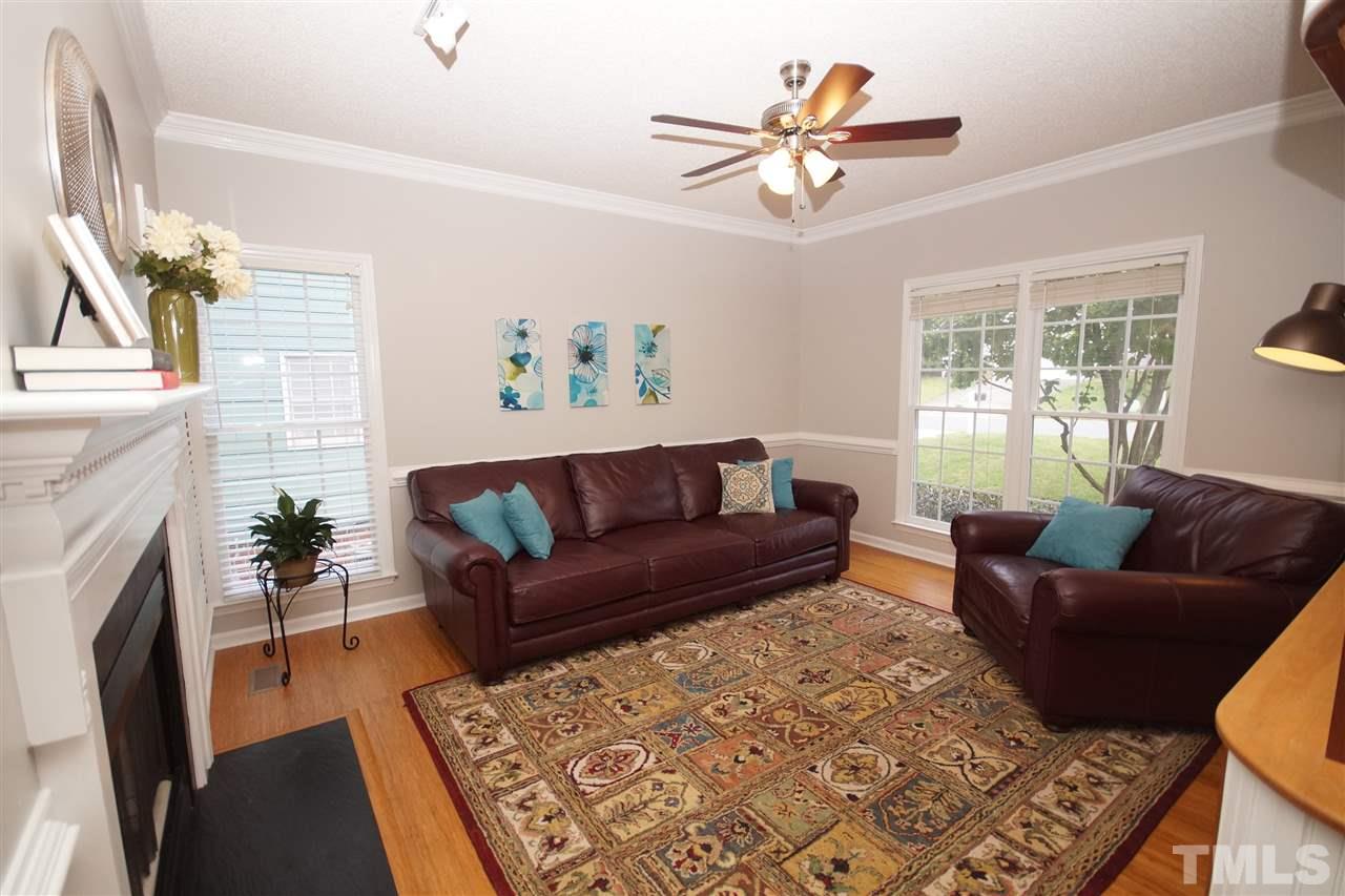12317 Hartwick Court Raleigh, NC 27613 - Photo 6 of 24 a living room with furniture and a fireplace