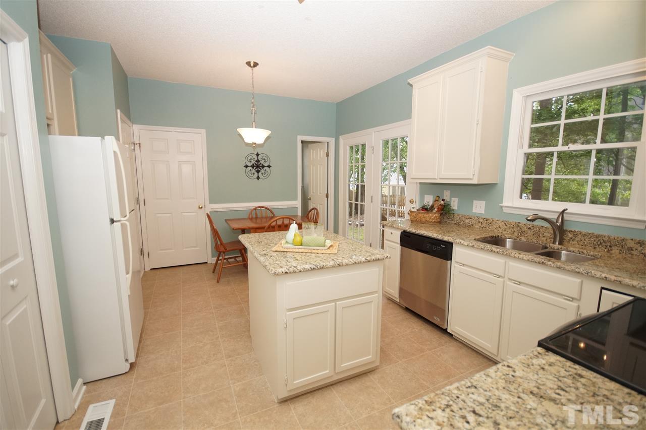 12317 Hartwick Court Raleigh, NC 27613 - Photo 8 of 24 a kitchen with a sink stove and cabinets