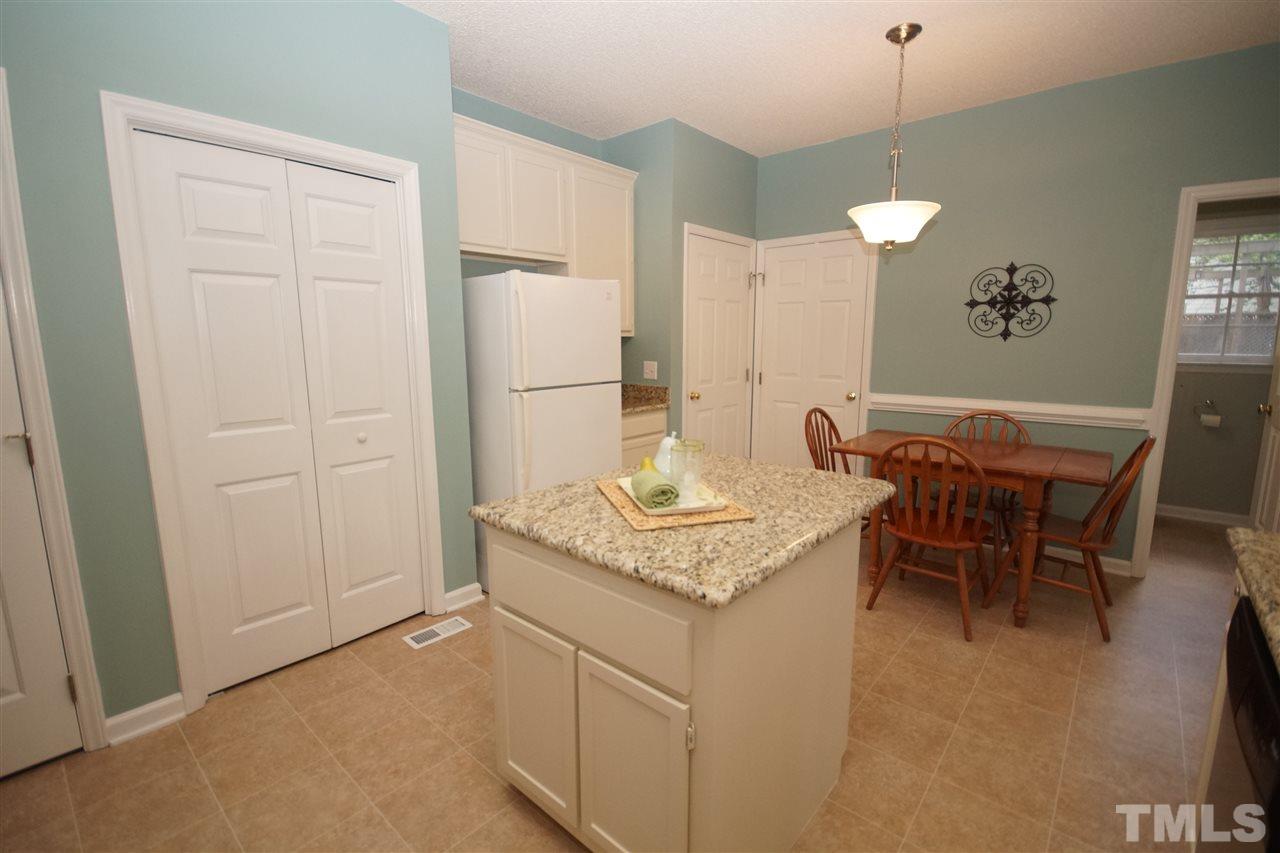 12317 Hartwick Court Raleigh, NC 27613 - Photo 9 of 24 a kitchen with a table and chairs in it