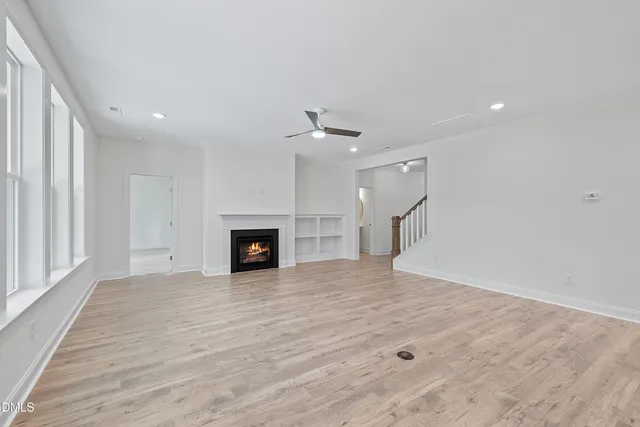 a large kitchen with stainless steel appliances granite countertop a lot of counter space and wooden floors