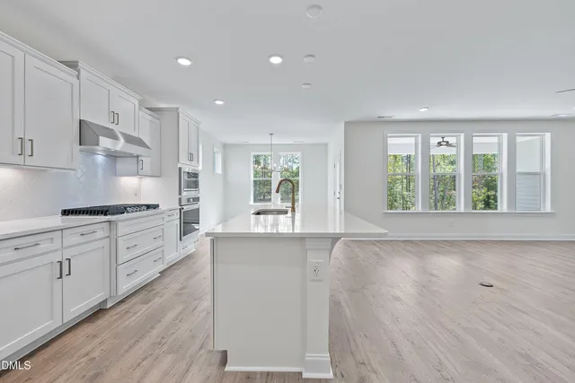 a bathroom with a toilet sink vanity and mirror