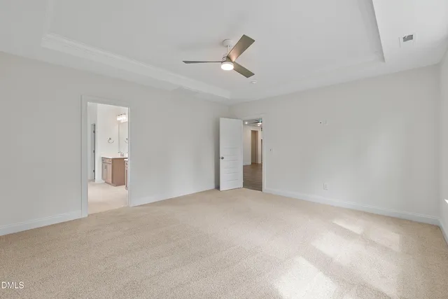 a view of an empty room with a ceiling fan