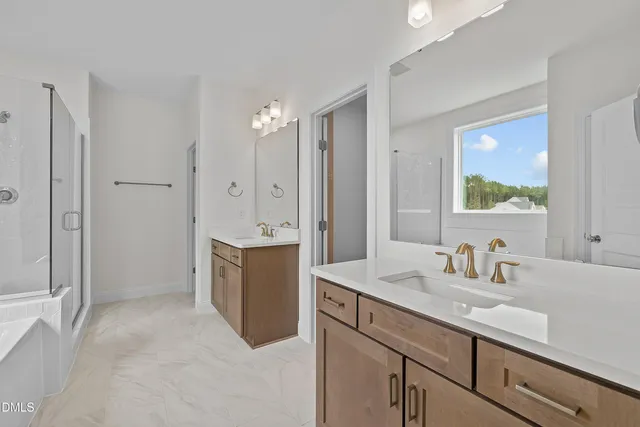 a bathroom with a sink double vanity and a mirror