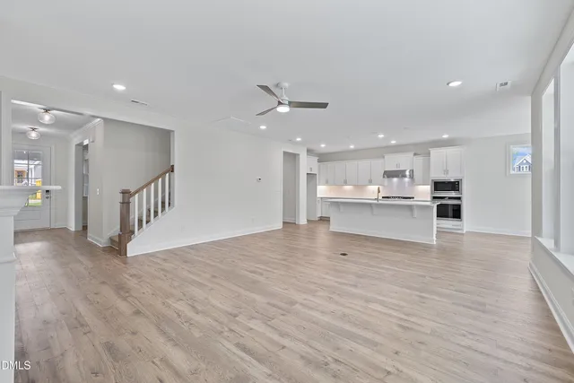 a view of an empty room with a window and fireplace