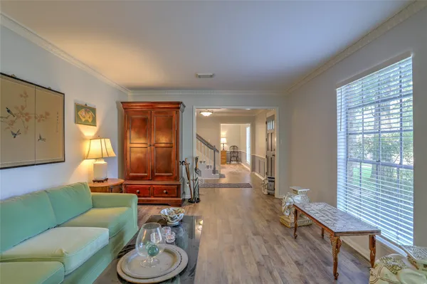 a view of a livingroom with wooden floor and stairs