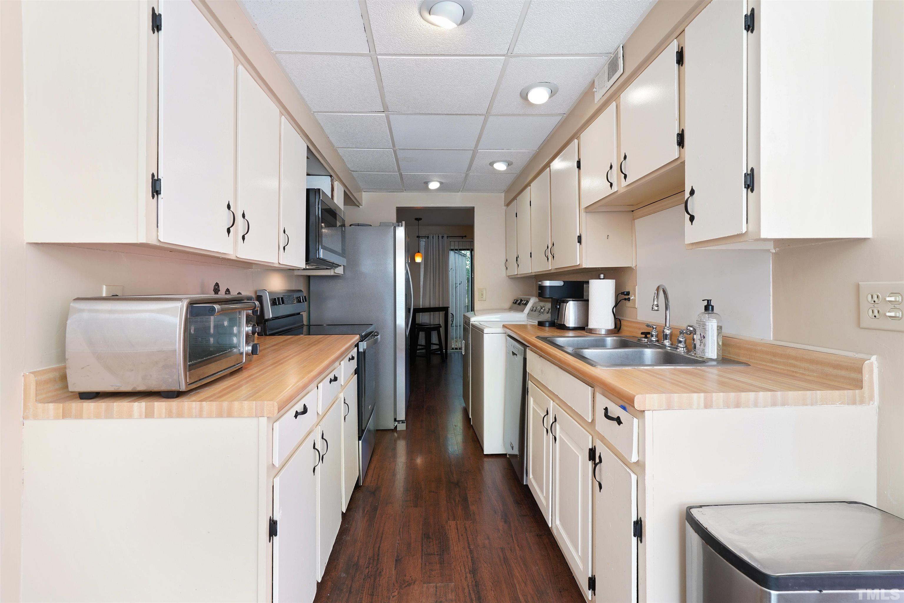1738 Quail Ridge Road Raleigh, NC 27609 - Photo 4 of 13 a kitchen with stainless steel appliances granite countertop a sink a stove and a refrigerator