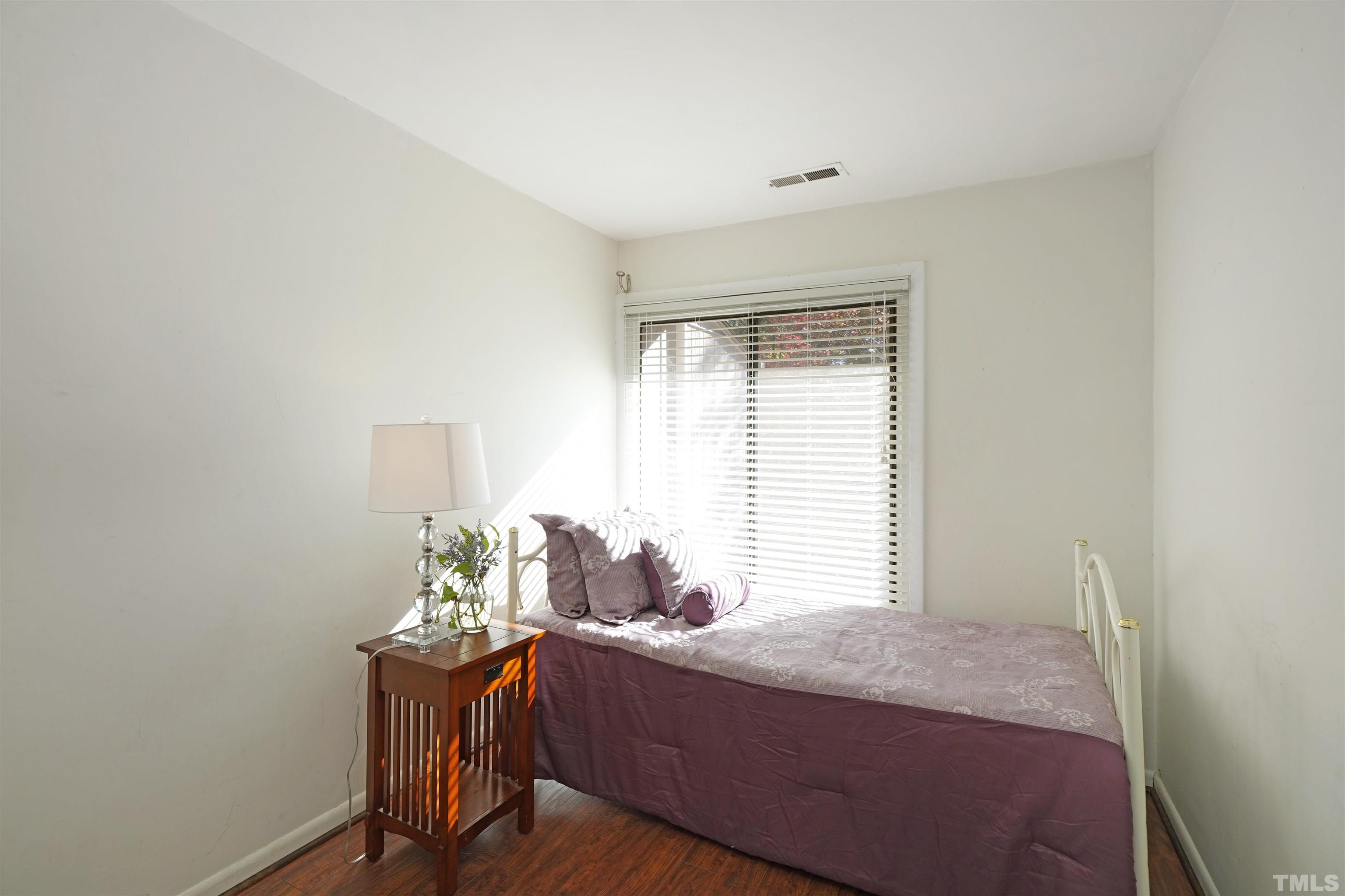 1738 Quail Ridge Road Raleigh, NC 27609 - Photo 8 of 13 a bed sitting in a bedroom next to a window