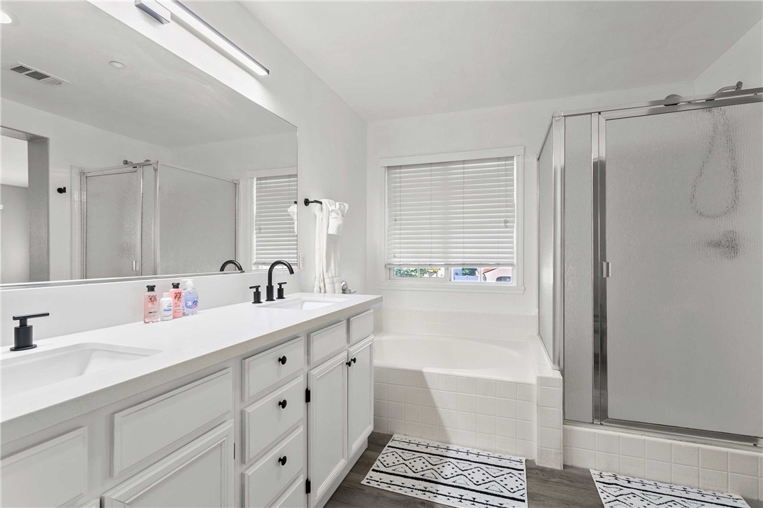 1746 Agrigento Avenue Riverside, CA 92507 - Photo 16 of 22 a bathroom with a double vanity sink mirror and shower