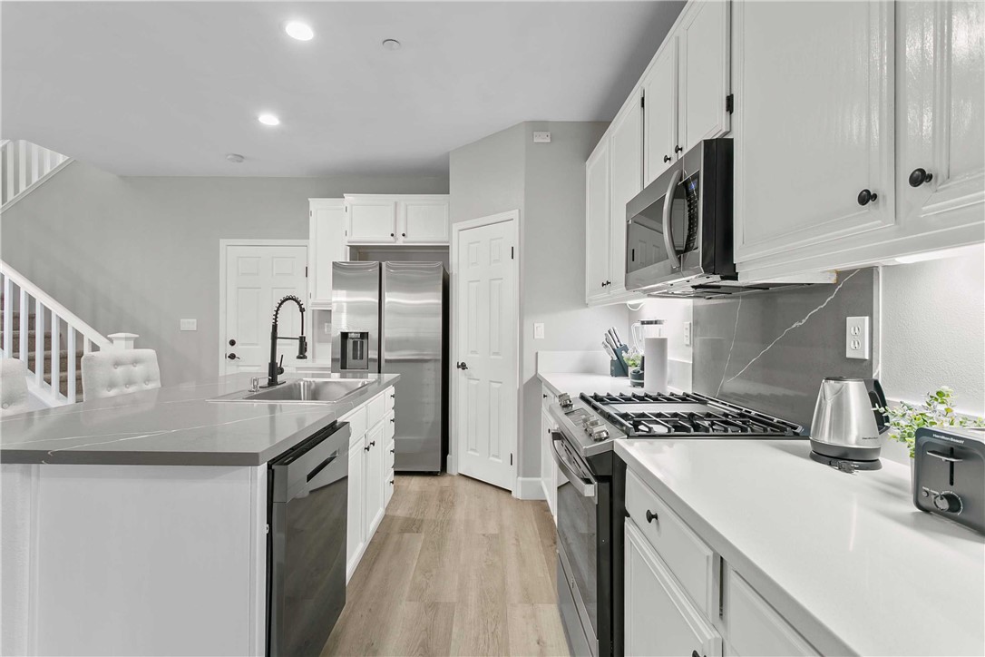 1746 Agrigento Avenue Riverside, CA 92507 - Photo 5 of 22 a kitchen with stainless steel appliances granite countertop a sink stove and refrigerator